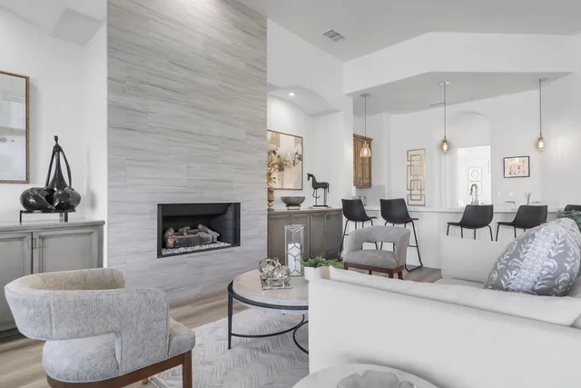a living room with furniture and a fireplace