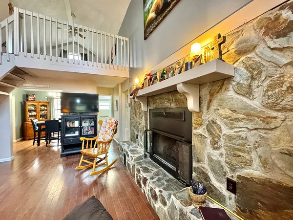 a living room with furniture and hard wood floor