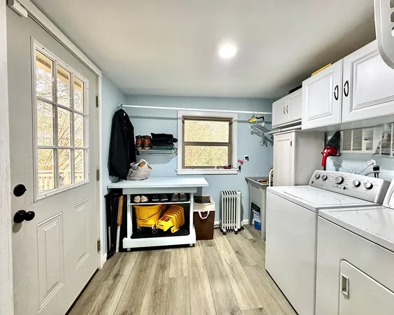 a kitchen with stainless steel appliances granite countertop a stove top oven a sink dishwasher and a microwave oven with white cabinets