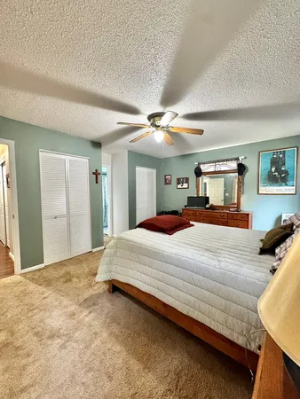 a bedroom with a large bed and a chandelier