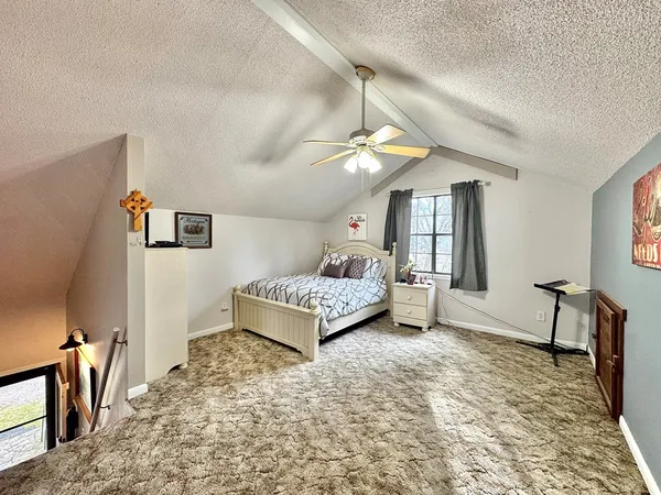 a bedroom with furniture and a window