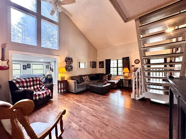 a living room with furniture a couch and a window