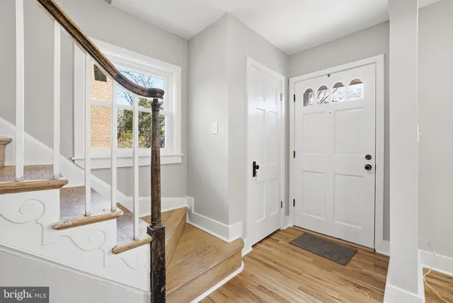 a view of a dining room with furniture wooden floor and chandelier