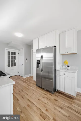 a view of a livingroom with furniture and hardwood floor