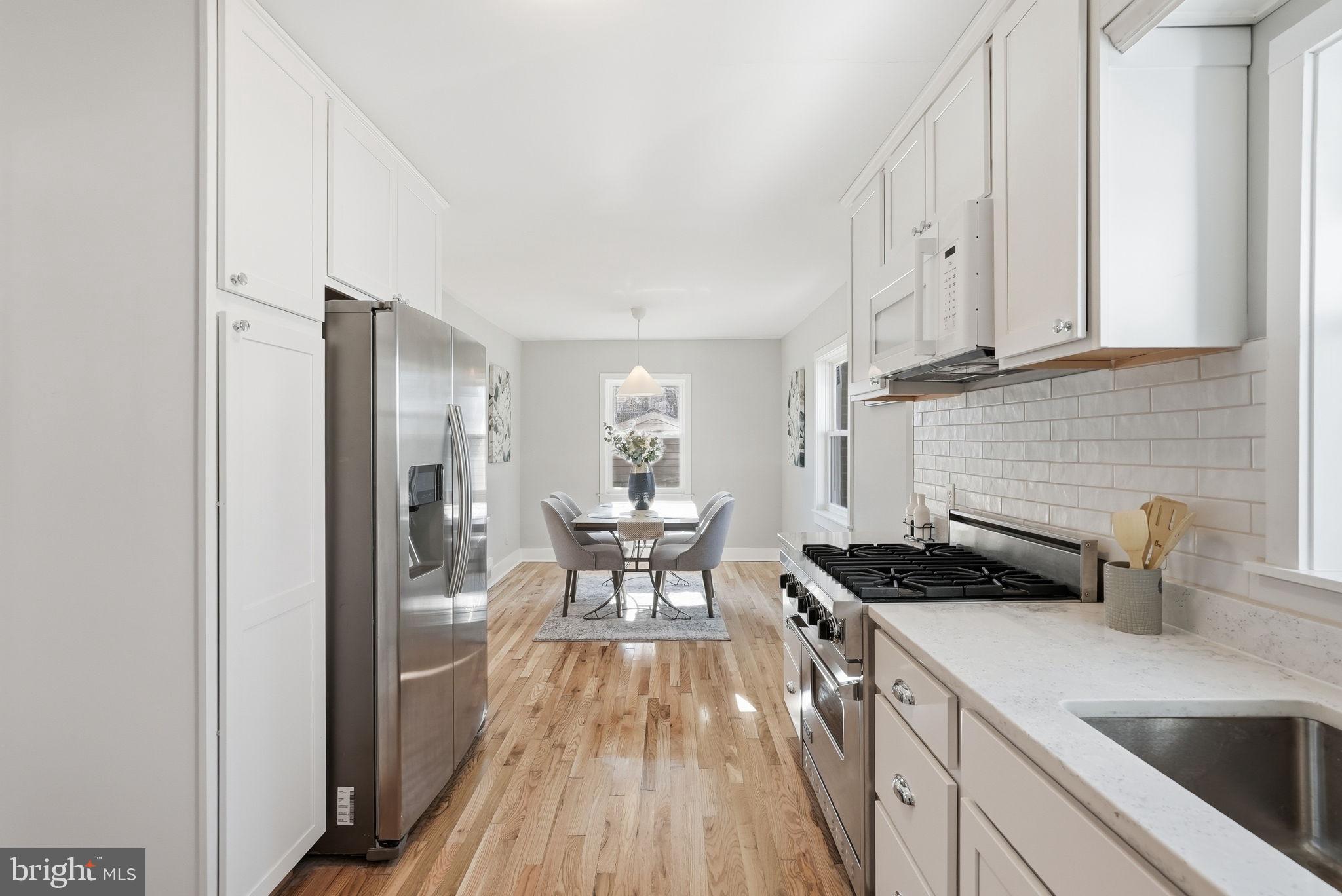 8712 Geren Road Silver Spring, MD 20901 - Photo 30 of 72 a kitchen with a sink a refrigerator and cabinets