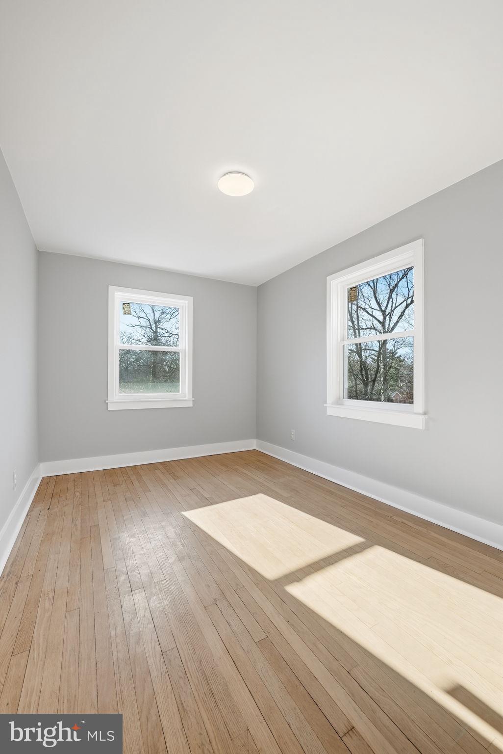 8712 Geren Road Silver Spring, MD 20901 - Photo 38 of 72 an empty room with wooden floor and windows