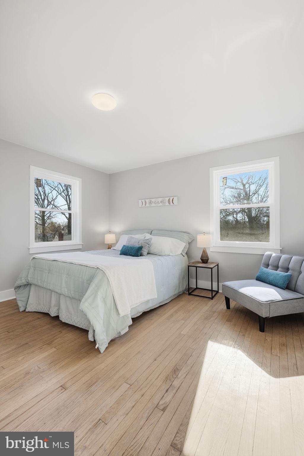 8712 Geren Road Silver Spring, MD 20901 - Photo 42 of 72 a bedroom with furniture and a wooden floor