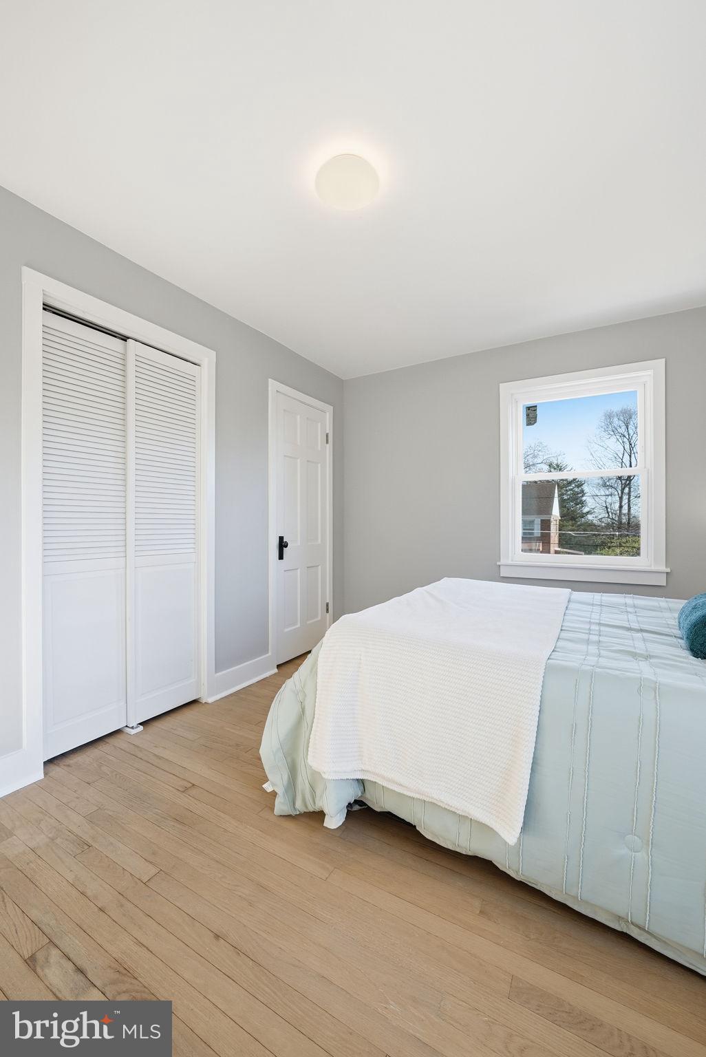 8712 Geren Road Silver Spring, MD 20901 - Photo 43 of 72 a bedroom with a bed and a painting on the wall