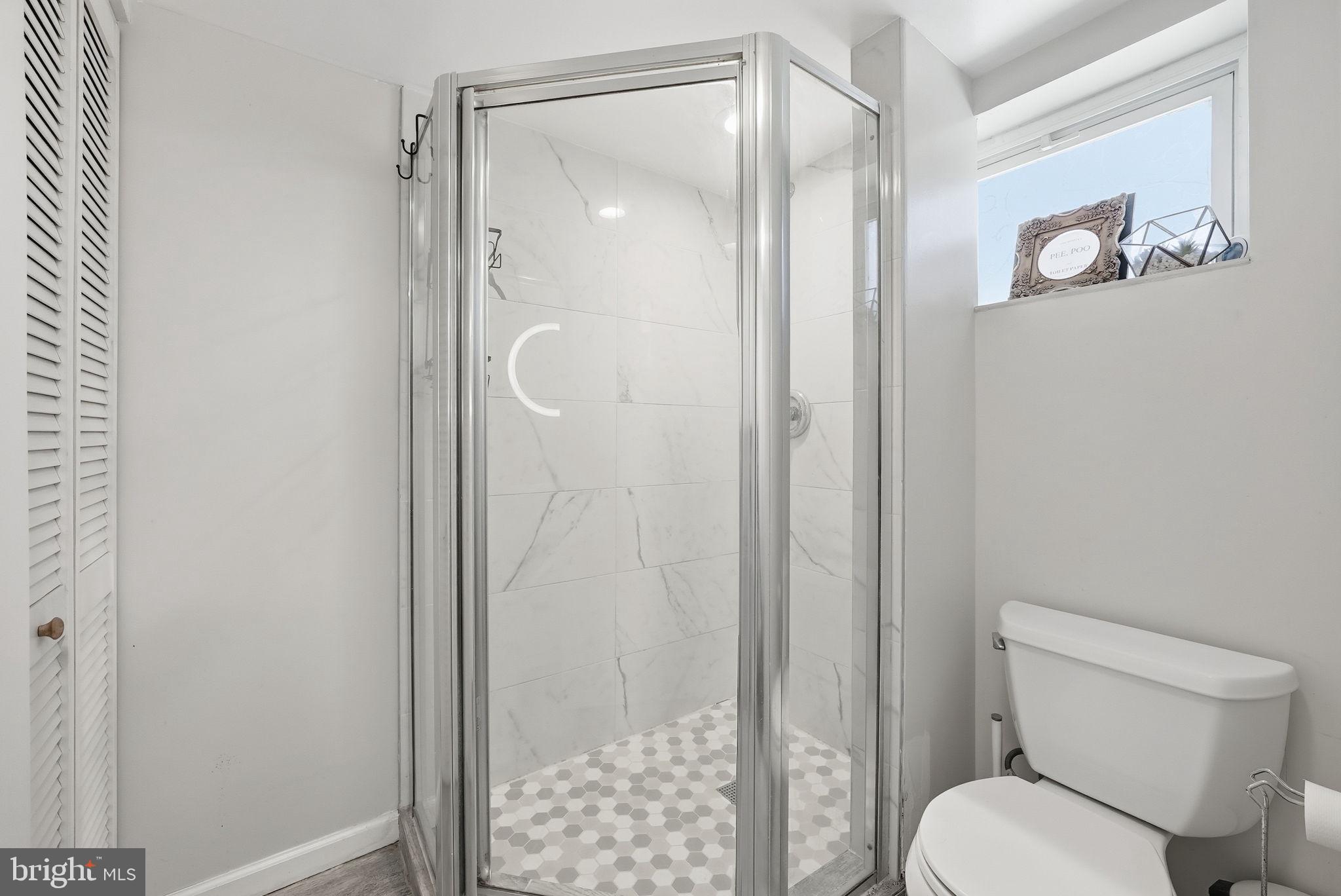 8712 Geren Road Silver Spring, MD 20901 - Photo 59 of 72 a bathroom with a shower and a toilet