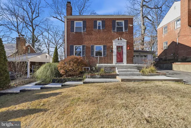 a living room with furniture a fireplace and a large window