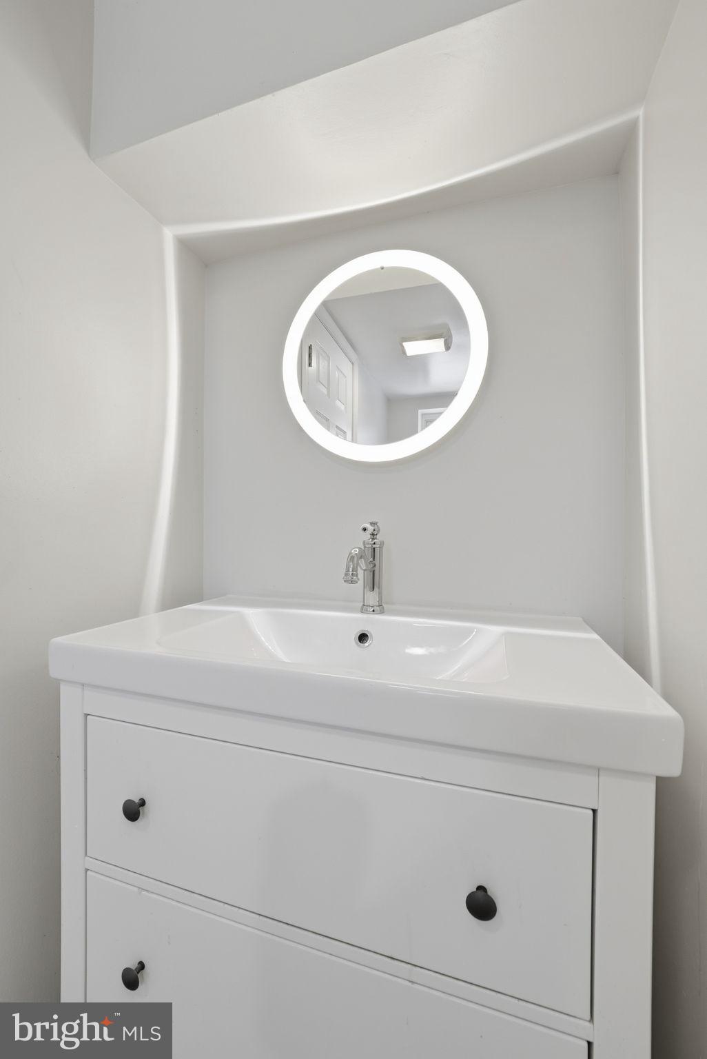 8712 Geren Road Silver Spring, MD 20901 - Photo 61 of 72 a bathroom with a sink and a mirror