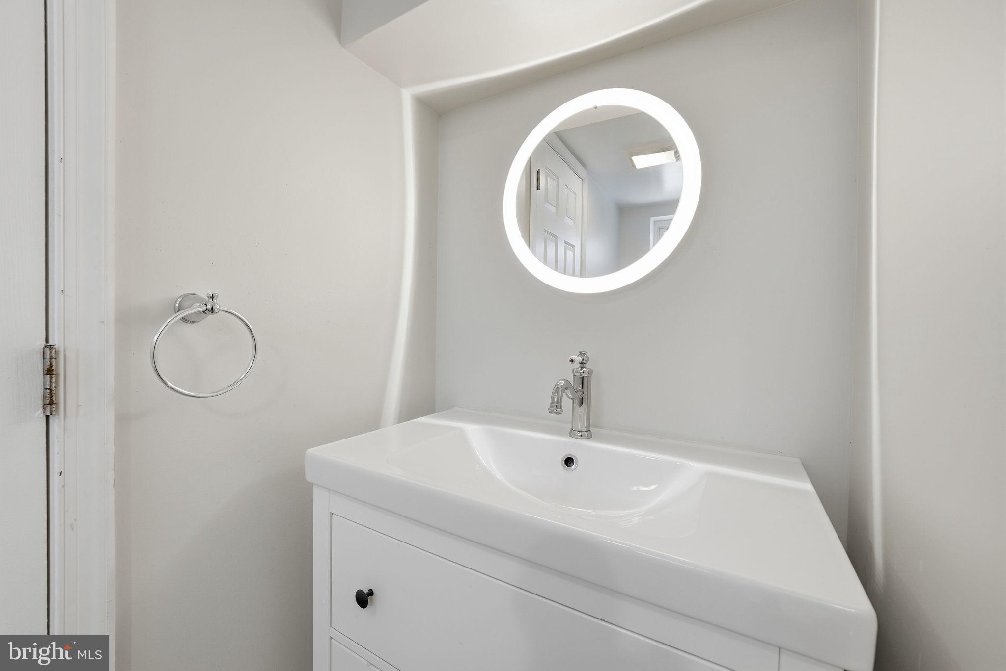 8712 Geren Road Silver Spring, MD 20901 - Photo 62 of 72 a bathroom with a sink and a mirror