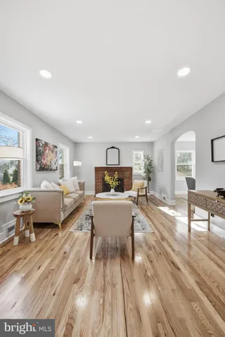 a living room with furniture and a painting on the wall