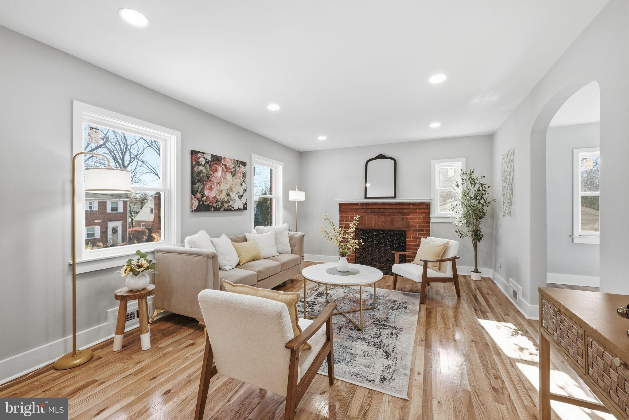 8712 Geren Road Silver Spring, MD 20901 - Photo 10 of 72 a living room with furniture a fireplace and a large window