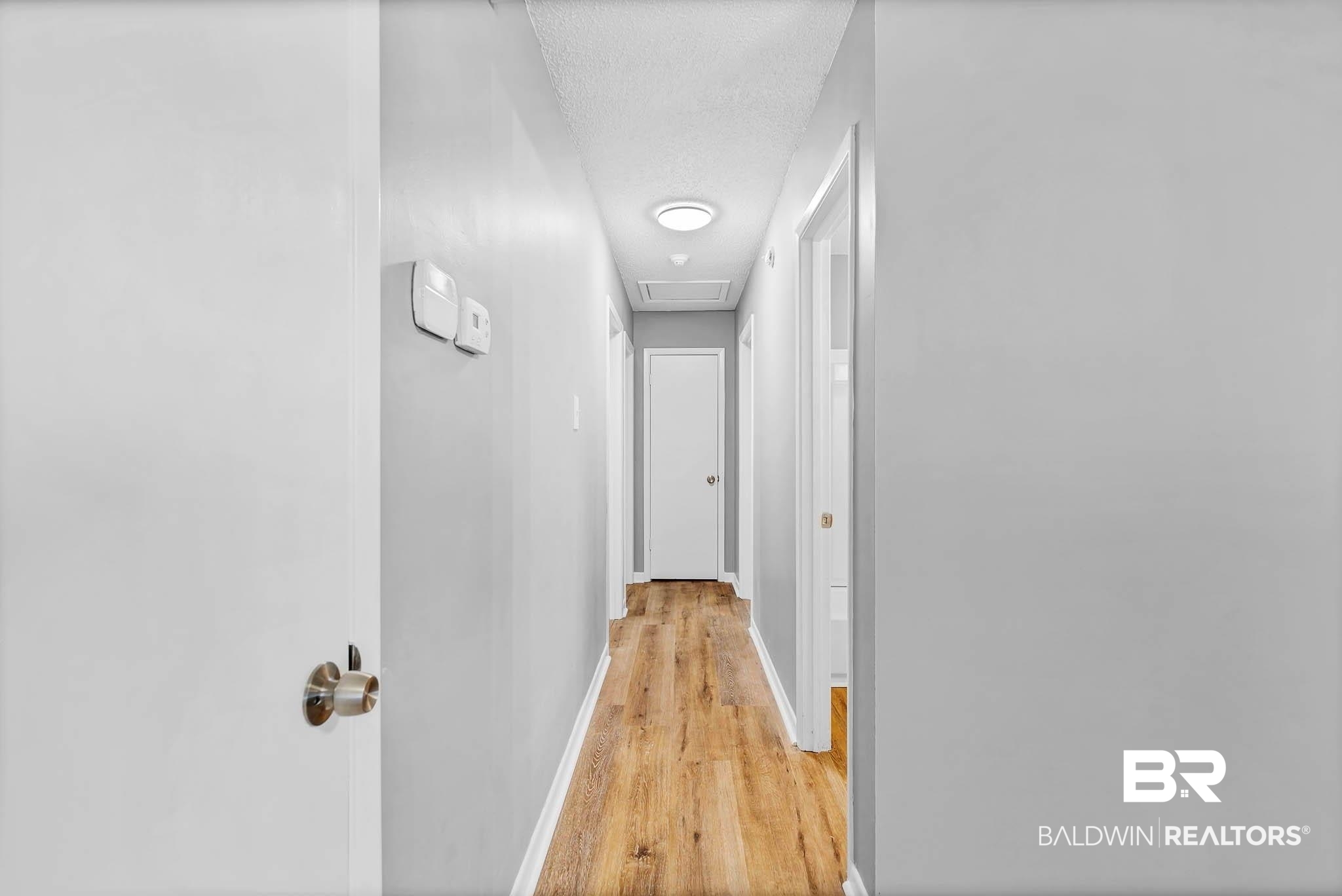 3304 Armond Drive Mobile, AL 36605 - Photo 26 of 62 Hallway with light wood-style floors and a textured ceiling
