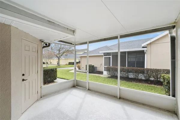a view of an empty room with a floor to ceiling window