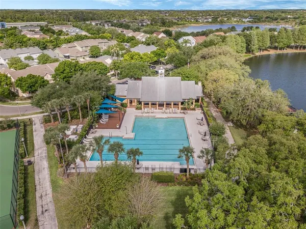 an aerial view of residential houses with outdoor space and river