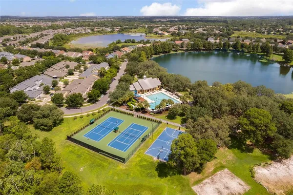 an aerial view of residential houses with outdoor space and swimming pool