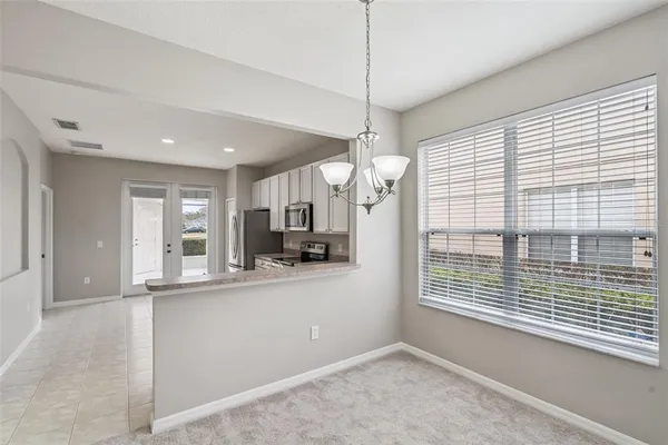 a view of a kitchen with a sink and windows