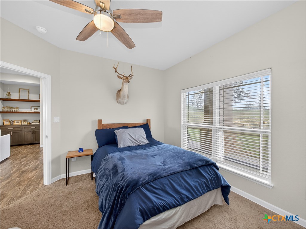 494 Flash Circle Luling, TX 78648 - Photo 22 of 44 a bedroom with a large bed and a window