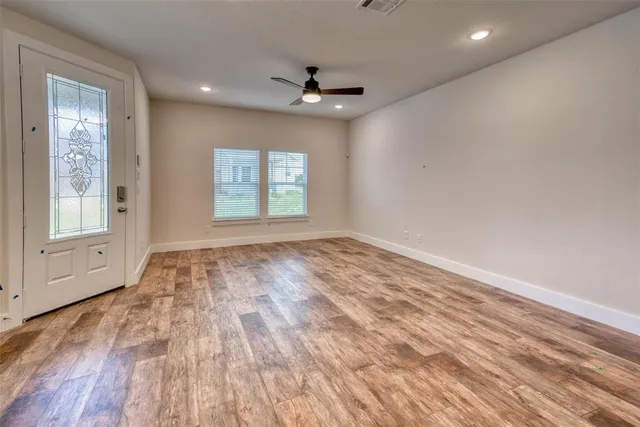 wooden floor in an empty room with a window