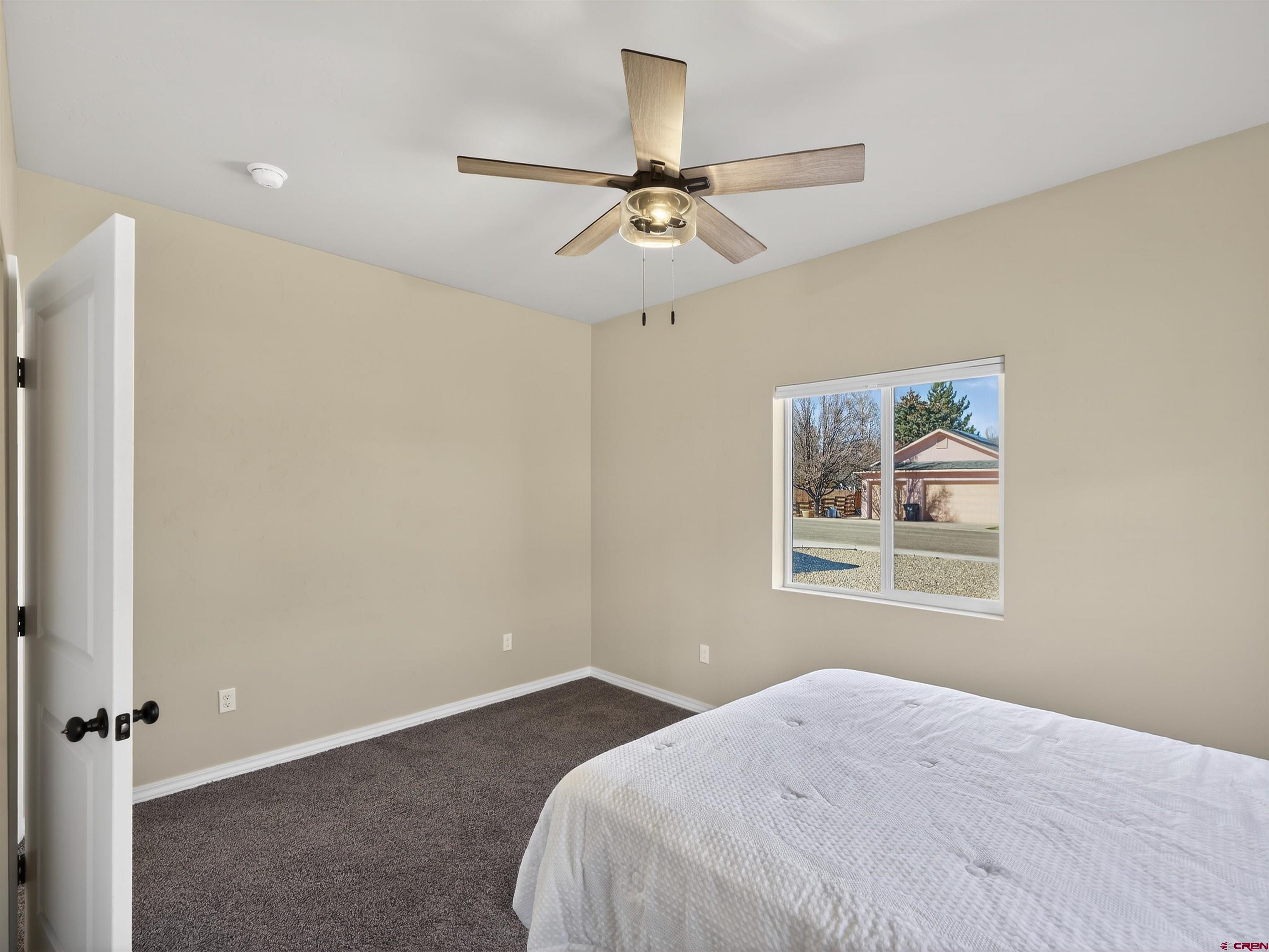 1615 Rivera Street Cortez, CO 81321 - Photo 13 of 21 a bedroom with a bed and a window