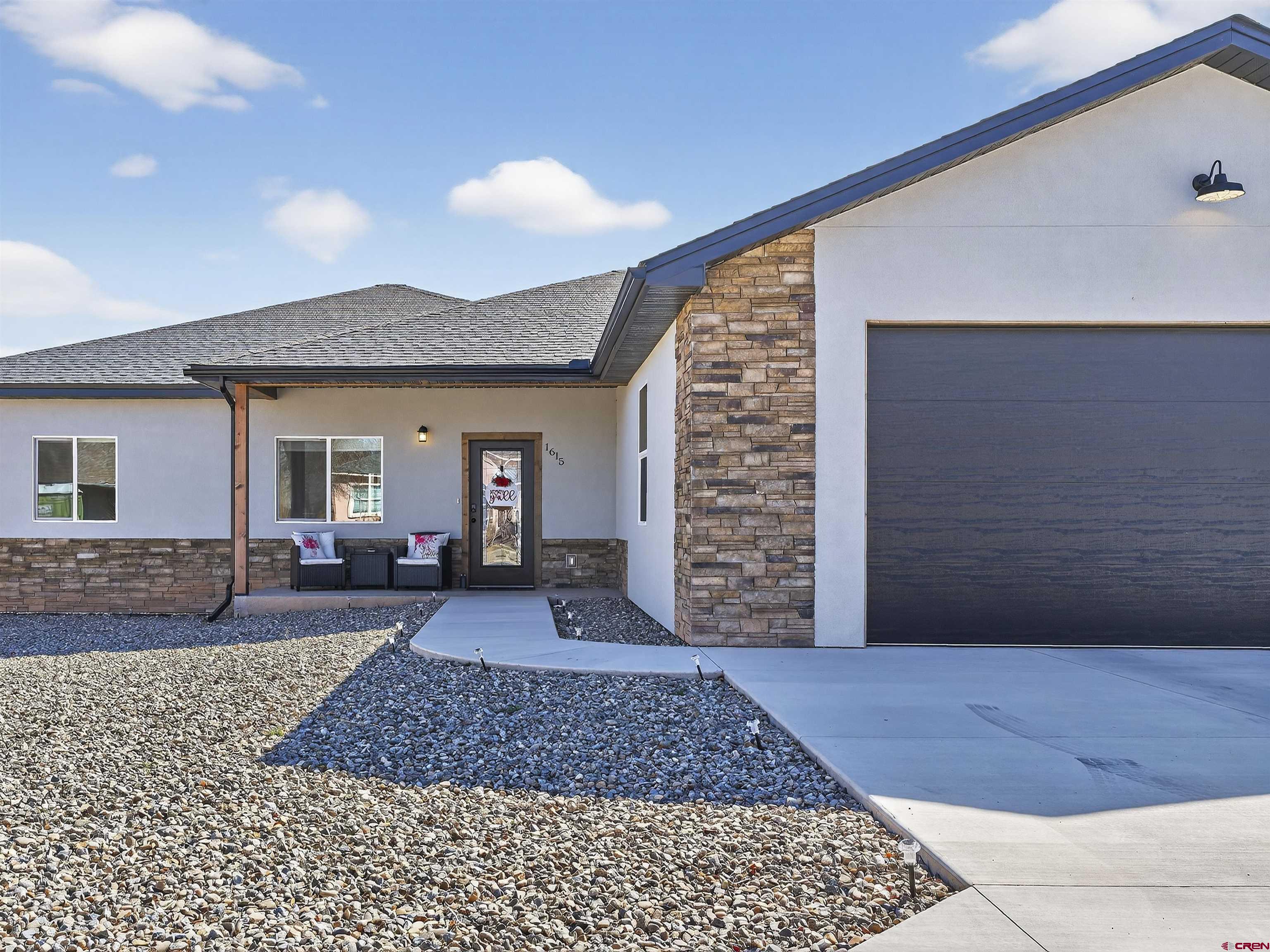 1615 Rivera Street Cortez, CO 81321 - Photo 2 of 21 a front view of a house with garden