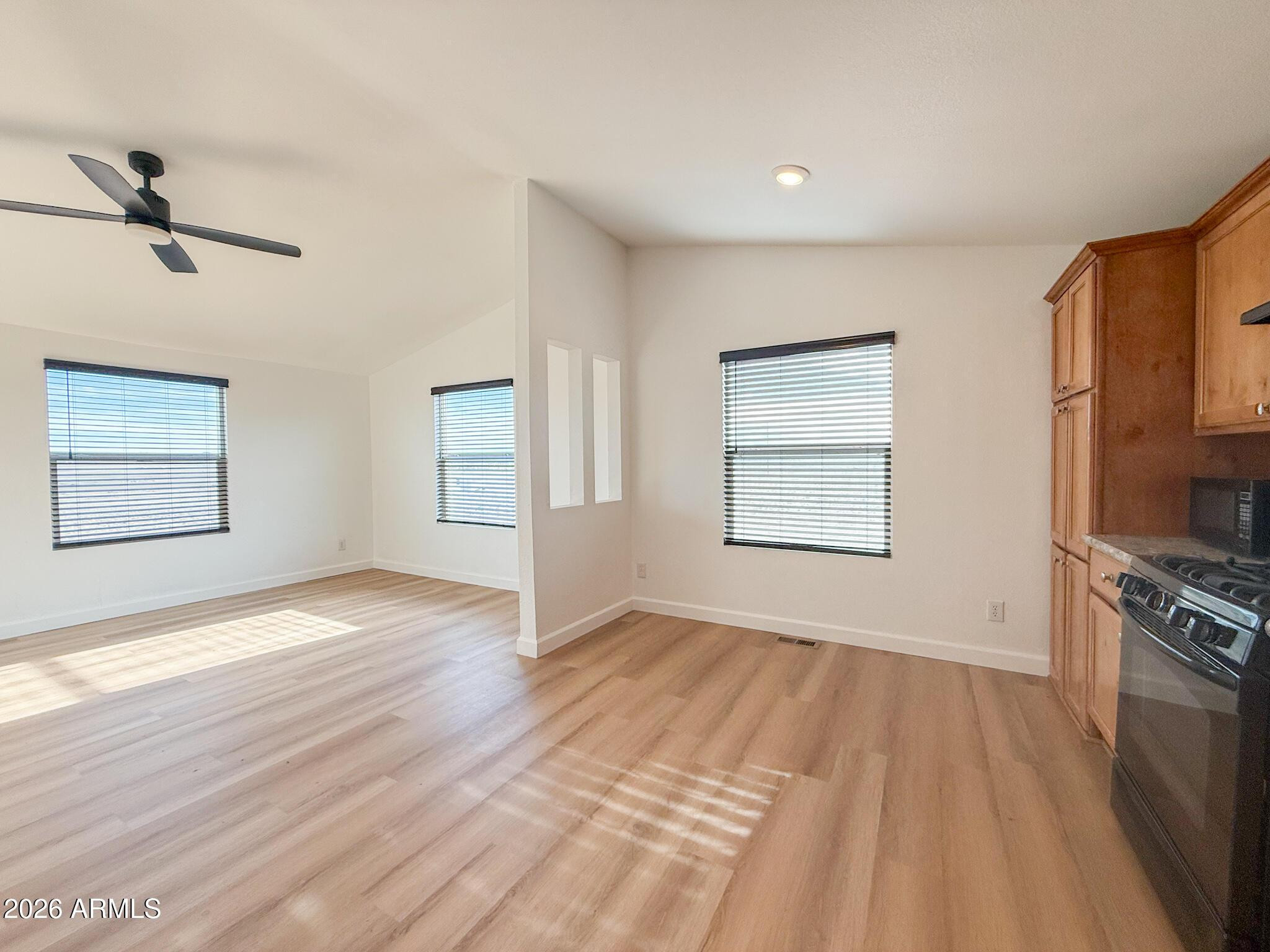 51880 North Gold Plains Road Seligman, AZ 86337 - Photo 11 of 24 an empty room with windows and fireplace