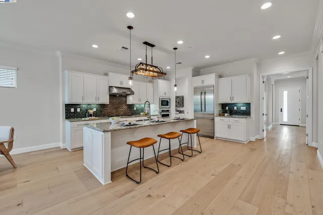 a kitchen with sink stove and cabinets