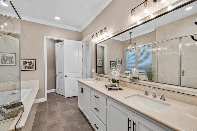 a bathroom with a tub a sink and a shower