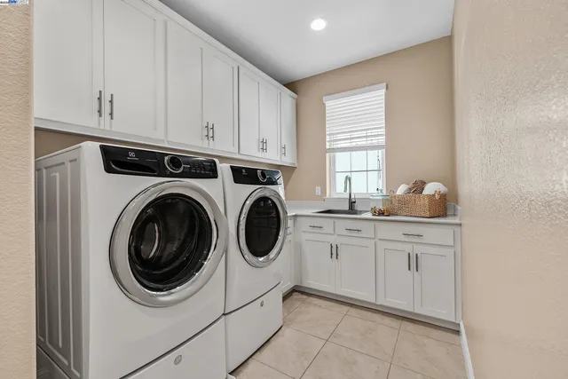 a spacious bedroom with a bed and a chandelier