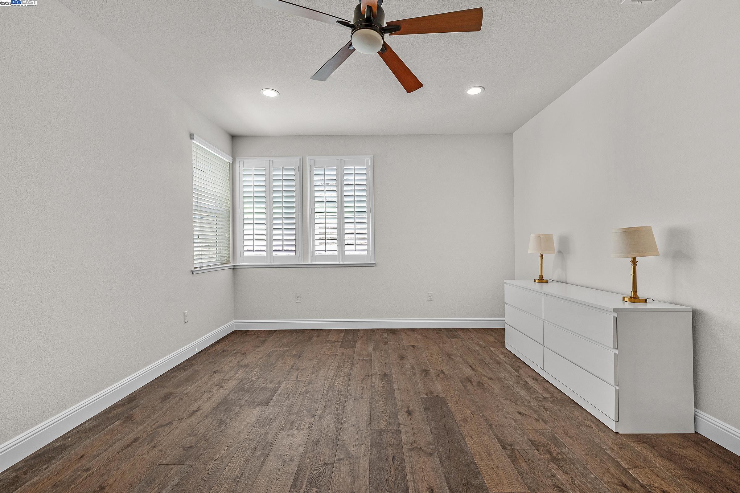 4519 Spring Mountain Way Dublin, CA 94568 - Photo 30 of 52 a view of empty room with wooden floor and fan