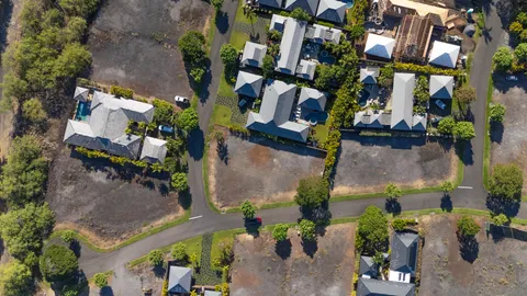 an aerial view of a house with a yard and a fountain