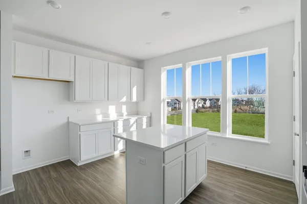 a kitchen with counter top space and wooden floor