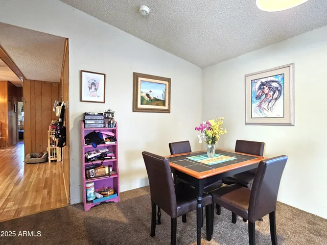 a dining room with furniture and wooden floor