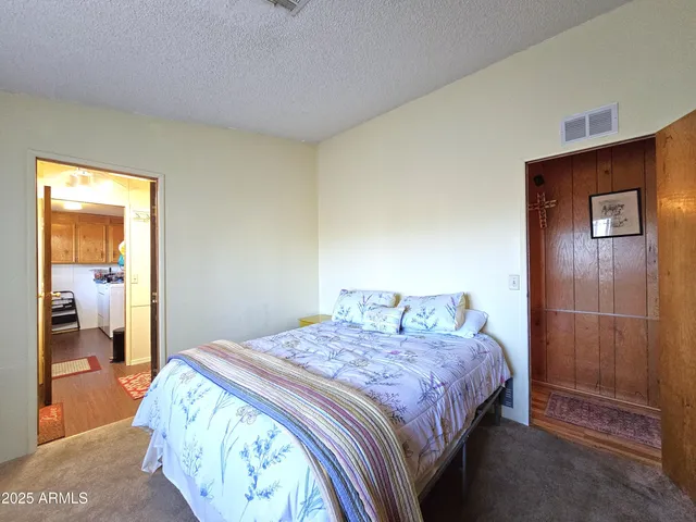 a bedroom with a bed and a mirror