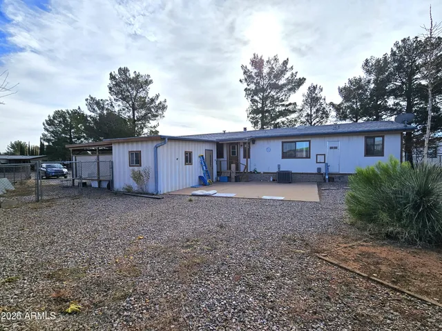 a view of a house with a yard and sitting area