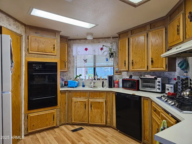 a kitchen with stainless steel appliances granite countertop a stove and cabinets
