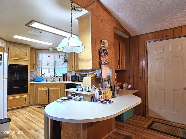 a kitchen with a table chairs and a wooden floor