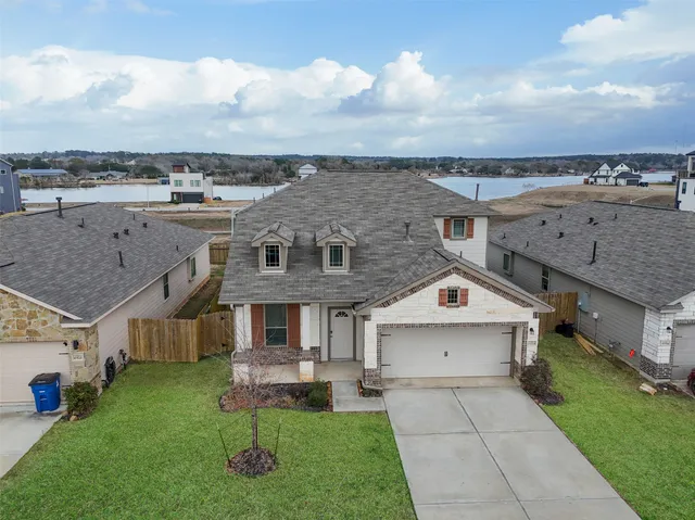 an aerial view of a house with a yard