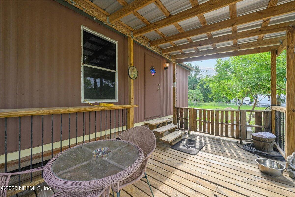 4961 Bent Twig Road Middleburg, FL 32068 - Photo 4 of 17 a balcony with table and chairs