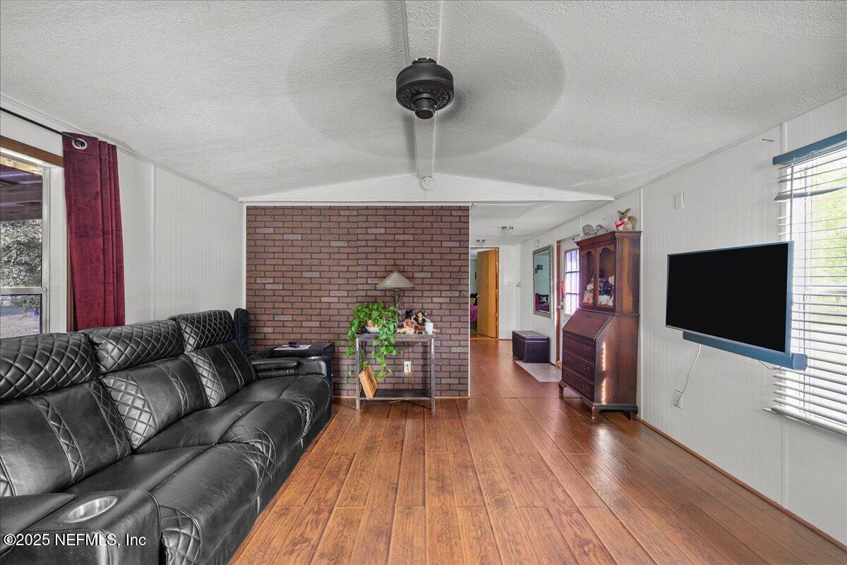 4961 Bent Twig Road Middleburg, FL 32068 - Photo 7 of 17 a living room with furniture and a flat screen tv
