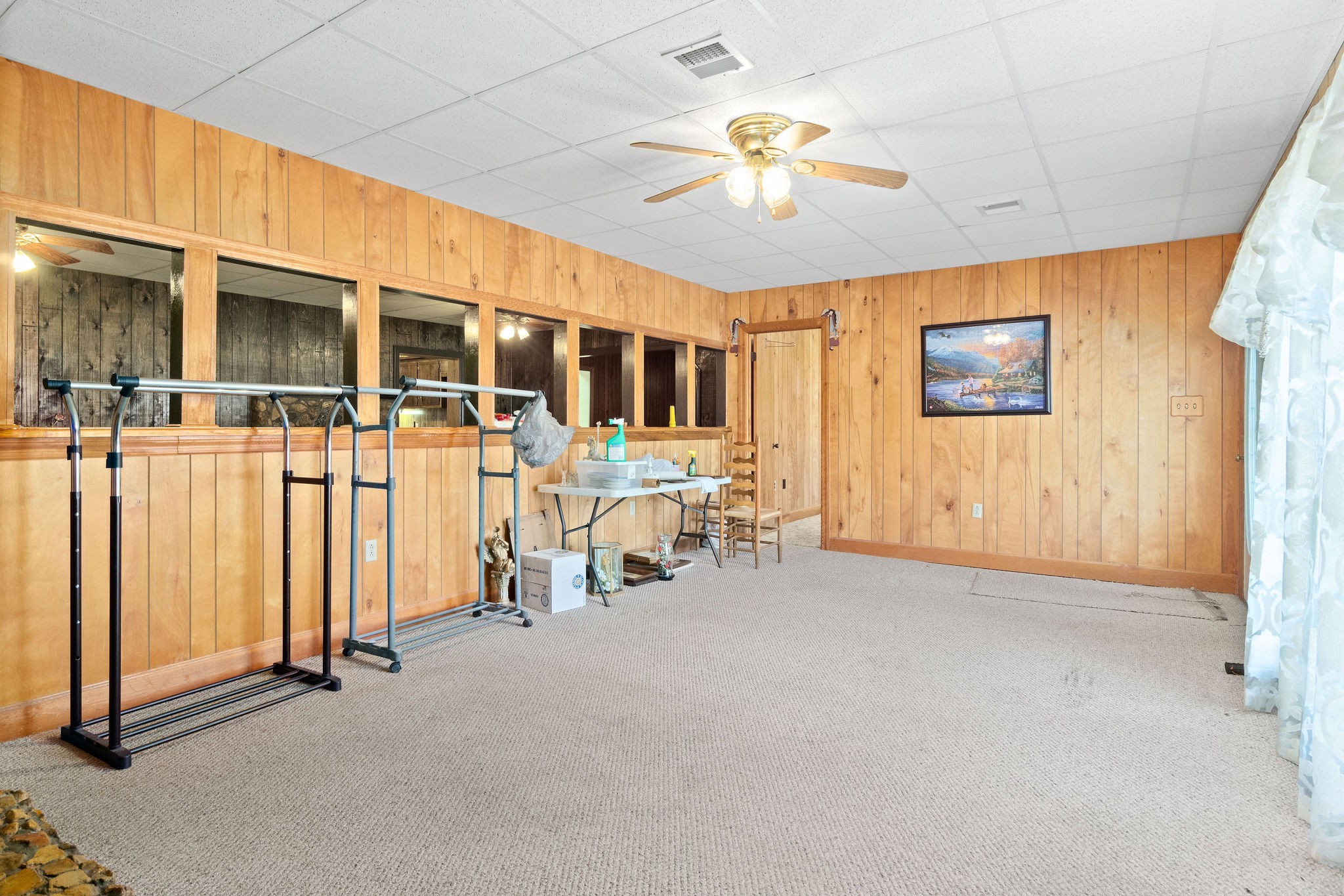 752 Highway 13 Cunningham, TN 37052 - Photo 7 of 32 an empty room with chandelier fan and windows