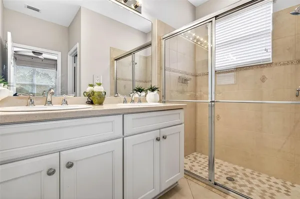a bathroom with a double vanity sink and a mirror