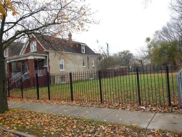 a view of a house with a large windows and a yard