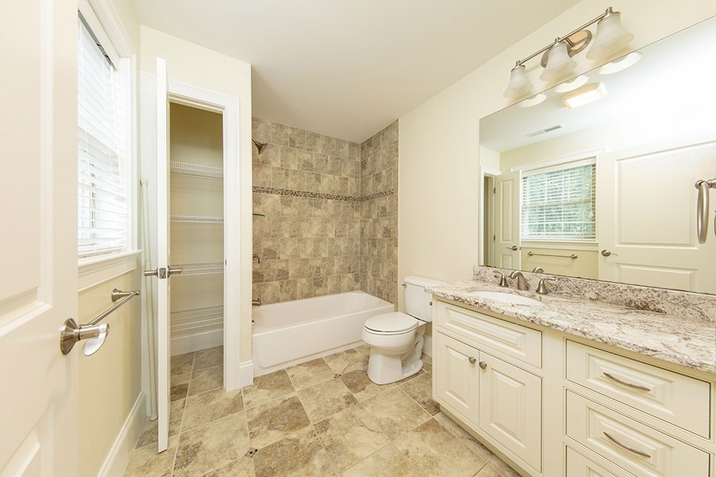 33 Liberty Avenue Lexington, MA 02420 - Photo 19 of 30 a bathroom with a granite countertop sink toilet and shower