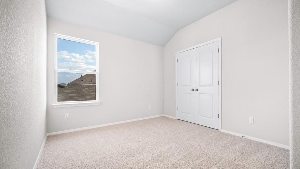 208 Stein Road Georgetown, TX 78626 - Photo 7 of 30 Unfurnished bedroom with carpet flooring, vaulted ceiling, and a closet