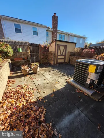 a view of a patio with table and chairs with wooden floor and fence