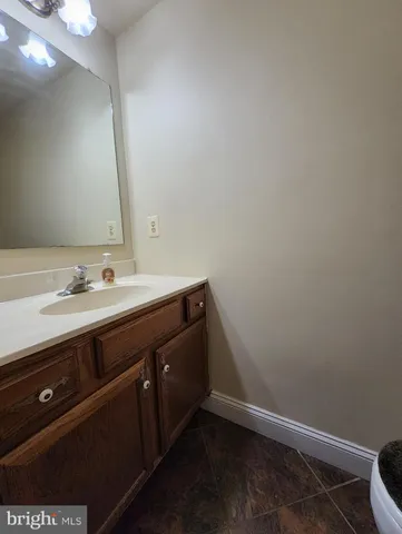 a bathroom with a sink vanity and a toilet