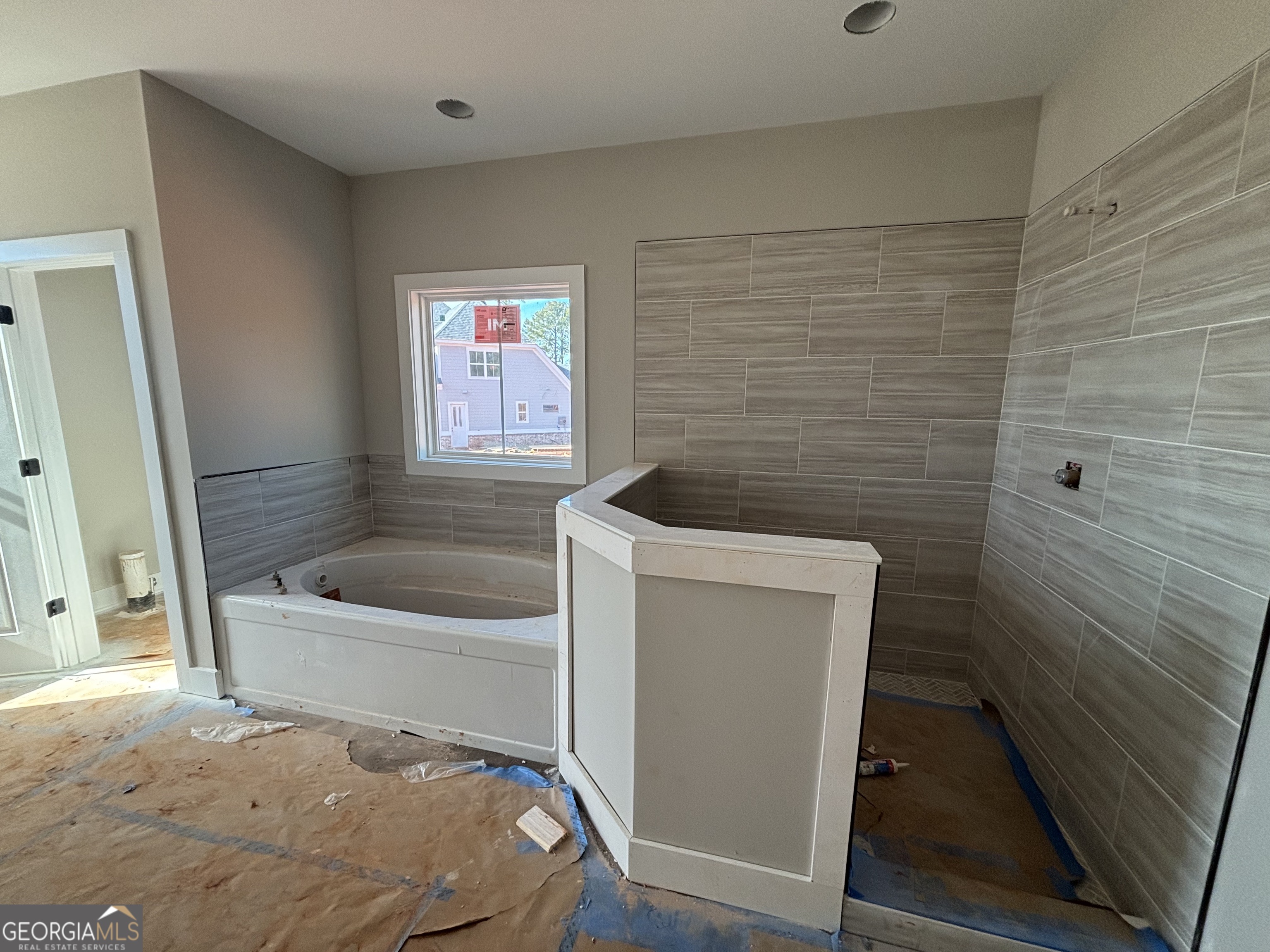 125 Hawthorne Lane Forsyth, GA 31029 - Photo 13 of 19 a bathroom with a tub and a shower